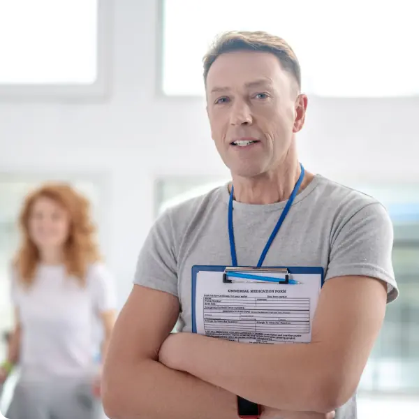 Coach holding clipboard